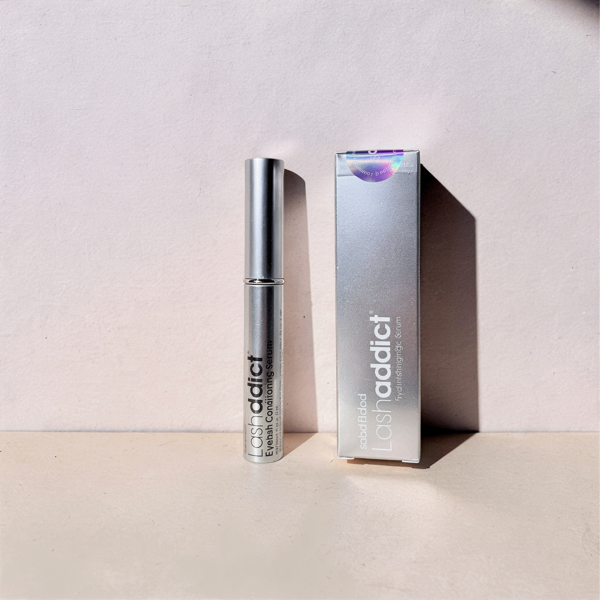 {
  "scene": "A minimalist product photography setup from image 1, featuring a two-toned pastel background. The bottom surface is a warm, matte light peach-beige plane, meeting a vertical back wall th