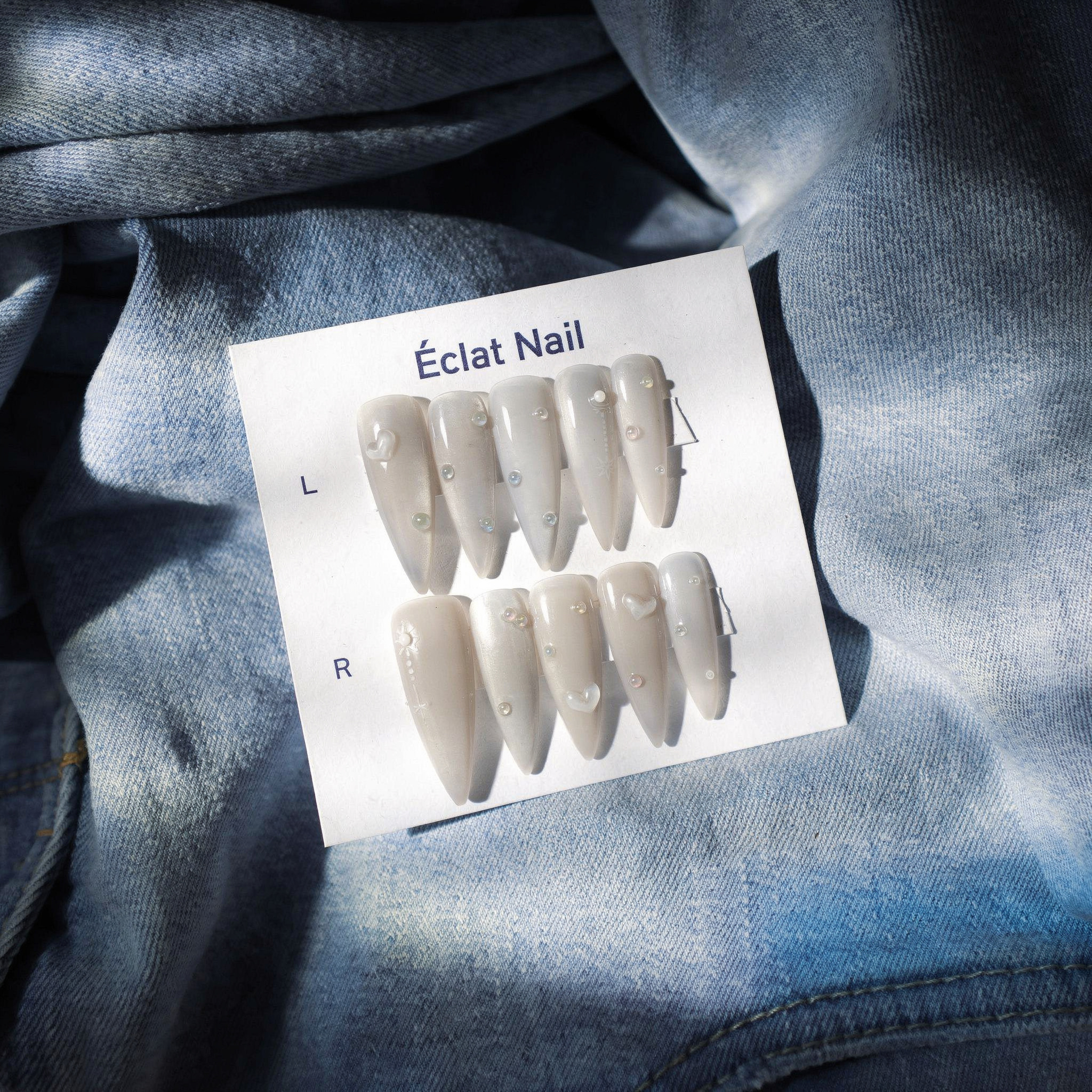 {
  "scene": "A photorealistic overhead product shot where the product from image 2 is placed onto the exact background setting from image 1. The scene features a bed of heavily textured, light blue d