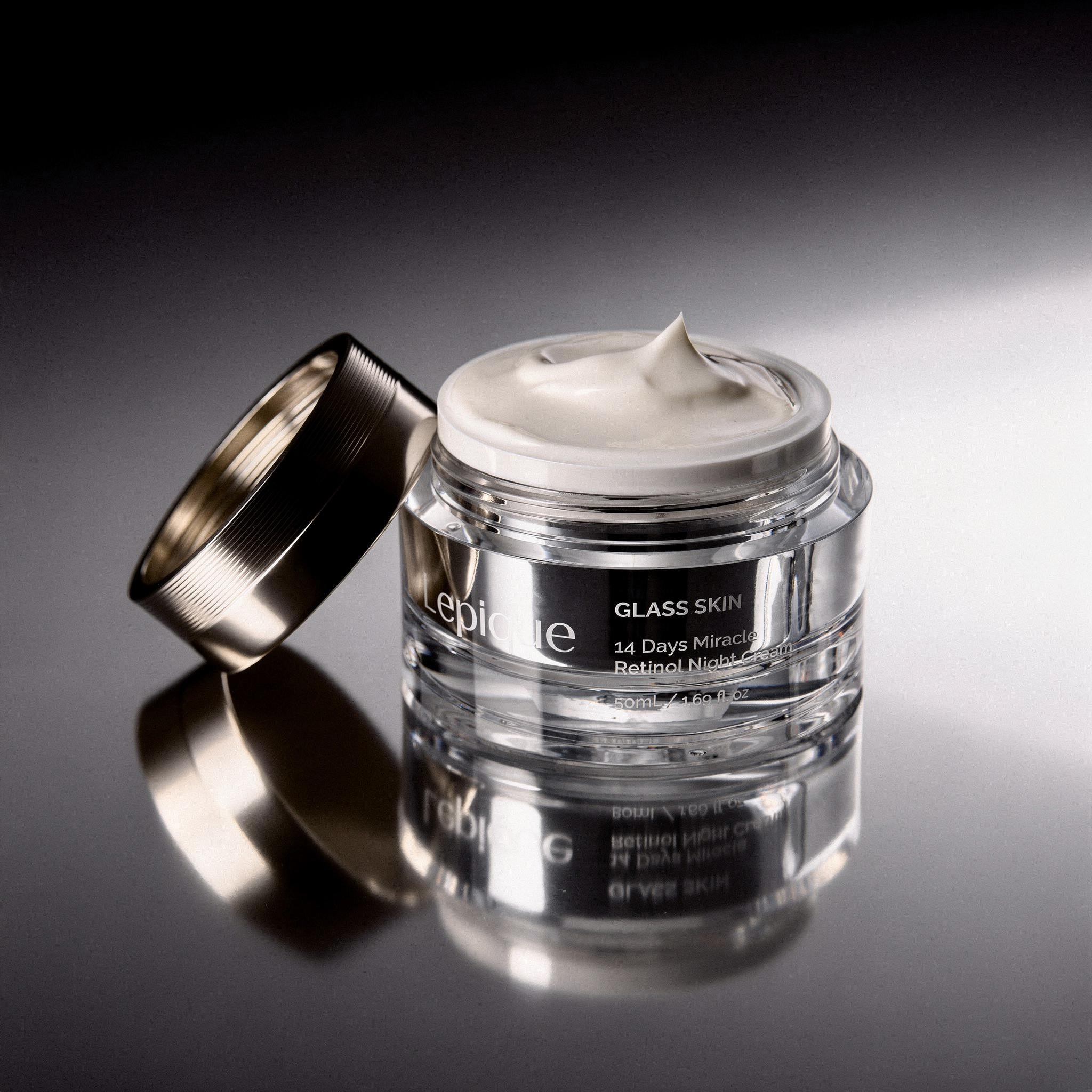 {
  "scene": "Professional cosmetic product shoot, replacing the jar in image 1 with the specific product from image 2 while maintaining the dark, reflective atmosphere and composition of image 1.",
 