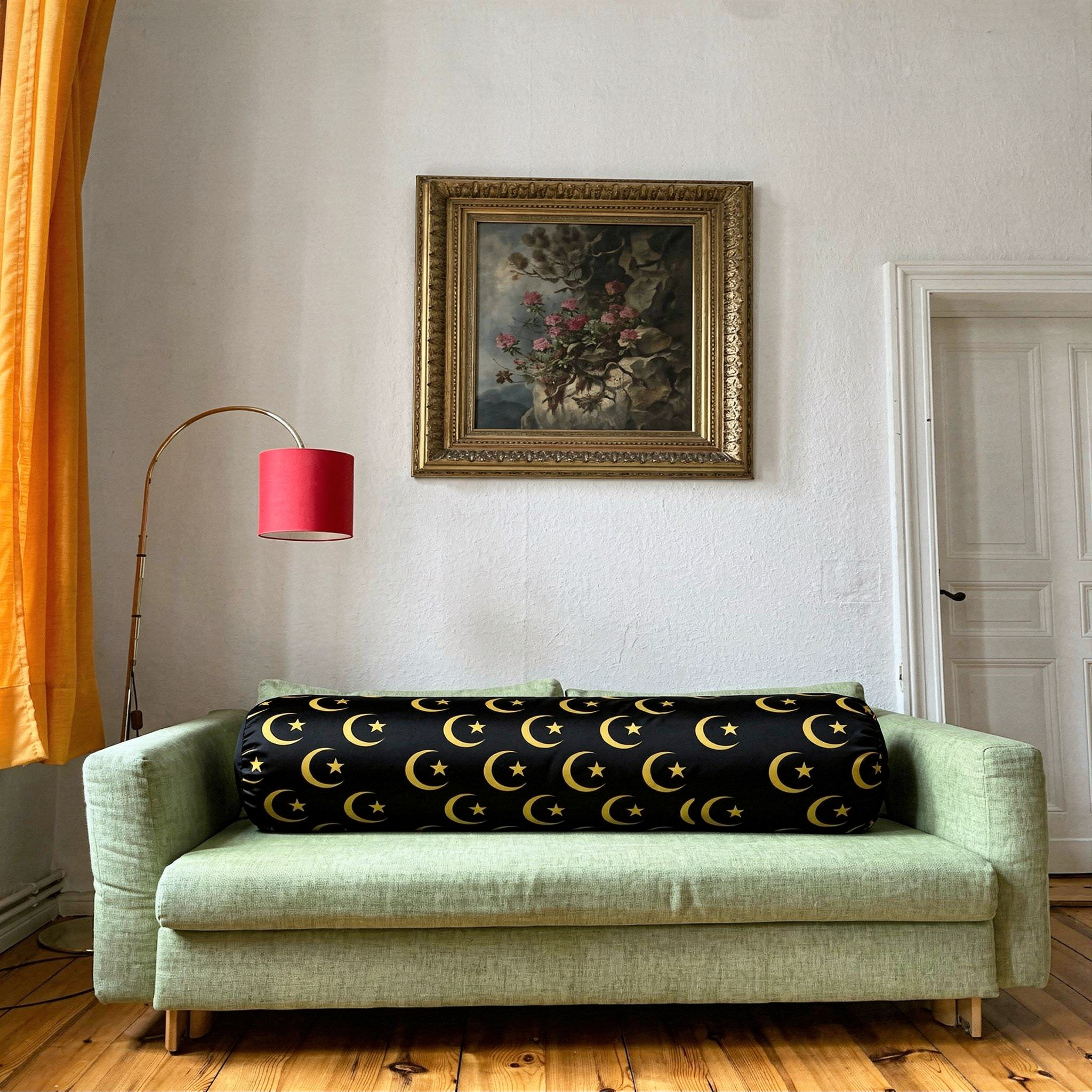 {
  "scene": "A clean, bright interior room based on the setting of image 1, featuring a light green upholstered sofa centered against a white wall. The original cushions of the sofa are replaced by t
