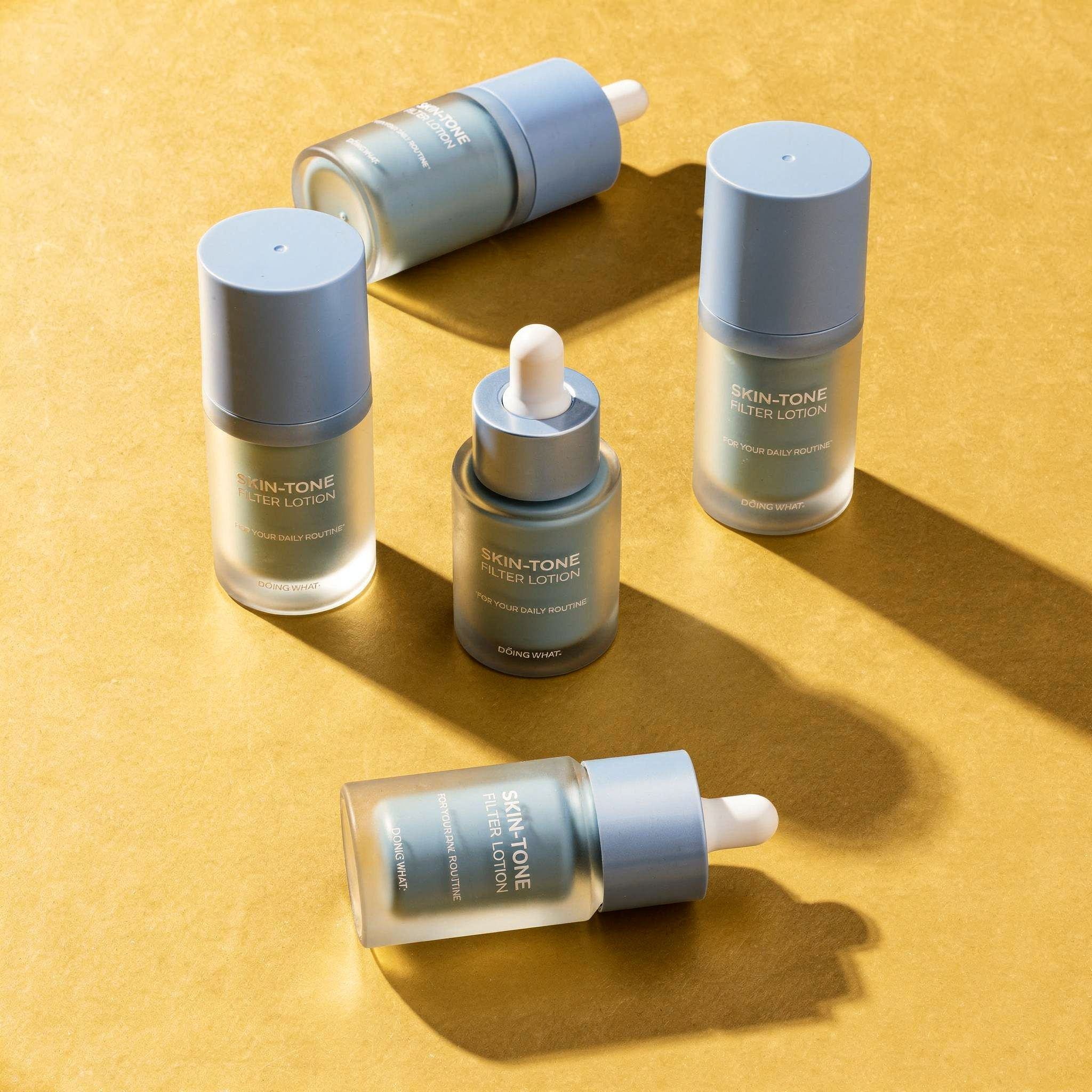 {
  "scene": "A high-end product photography scene matching the environment, layout, and composition of image 1, but featuring the product from image 2. Three identical lotion bottles are scattered ac