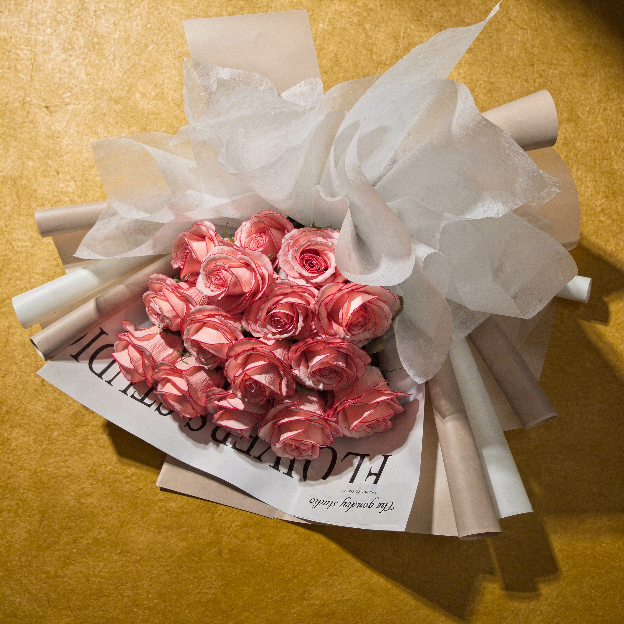{
  "scene": "A minimalist flat-lay product photograph set on a textured mustard-yellow surface, replicating the environment and high-contrast lighting of image 1. The scene features the rose bouquet 